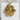 Gold vermeil honey bee pendant displayed on a white textured concrete block showing intricate wing details