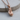 Laced Boxing Glove Pendant, rose gold, product photo on wood