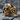 All-Seeing Eye Masonic Skull Ring, gold vermeil, front angled view on rock