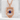 Lapis Dragon Pendant, rose gold, front view on stone pedestal