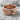 Overlapping Dragon Scale Ring, rose gold, front view on rock surface