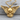Outspread Winged Skull Pendant, gold vermeil, front view on wood base