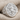 Saint Rose of Lima Ring, polished silver, angled front view on fabric