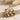 Ghost Flower Pendant, gold vermeil, product photo on stone surface