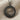 Hittite Sun Standard Pendant, black rhodium, product photo on fabric