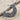 Scroll Crescent Star Pendant, oxidized, angled view on sand with driftwood