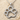 Paw Print Pendant, polished silver, front view on sand