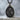 Saint Padre Pio Medal Pendant, black rhodium, angled product photo with chain