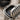 Reeded Barrel Locket Ring, oxidized silver, close-up angled view showing inner cavity