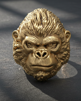 Close-up front view of realistic gorilla head ring design displaying heavy metalwork and bold animal features