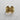 Front view of gold vermeil gothic skull ring with ornate filigree details on textured background