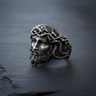 Oxidized Silver Jesus Ring showcasing the detailed Crown of Thorns and serene facial expression on a dark slate surface.