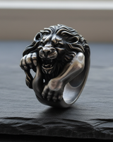 Handcrafted 925 sterling silver roaring lion ring displaying intricate mane details on textured black slate background
