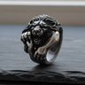 Handcrafted 925 sterling silver roaring lion ring displaying intricate mane details on textured black slate background
