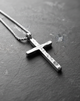 Rustic 925 sterling silver cross necklace with hammered finish displayed on dark slate background