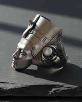 Profile view of handcrafted silver Nefertiti ring featuring a gold-plated headdress and oxidized finish on dark stone background