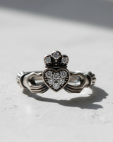 925 sterling silver Claddagh ring featuring crystal paved heart and crown design on white background