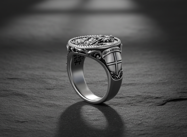 Angled view of silver signet ring with Saint George engraving and textured inner band design