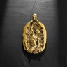 Gold vermeil self made man pendant featuring a muscular figure carving himself out of stone on dark background
