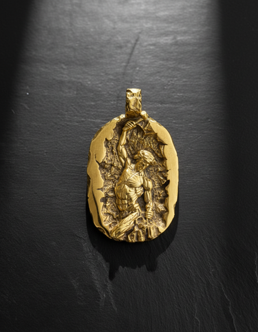 Gold vermeil self made man pendant featuring a muscular figure carving himself out of stone on dark background