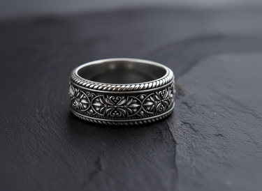925 sterling silver vintage floral ring with rope borders on black stone surface