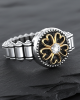 Elegant 925 sterling silver clover ring featuring a gold-outlined four-leaf design and central stone on dark background