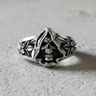 Front view of 925 sterling silver Grim Reaper ring showing hooded skull and floral band details on textured grey background