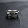 Front view of 925 sterling silver Celtic cross ring with interwoven knot patterns on black slate background