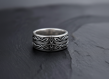 Front view of 925 sterling silver Celtic cross ring with interwoven knot patterns on black slate background