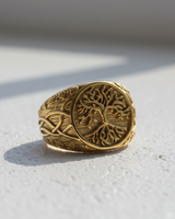 Gold vermeil Yggdrasil ring featuring the Tree of Life with intricate branches and roots on a textured background