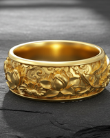 Silver lotus flower ring with gold vermeil finish displaying intricate floral relief on dark stone