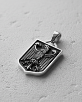 Angled view of silver German coat of arms pendant showing oxidized vertical lines and sturdy bail loop detail