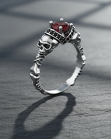 Handcrafted sterling silver skeleton ring with central red stone and realistic skull details for alternative style