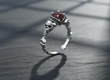 Handcrafted sterling silver skeleton ring with central red stone and realistic skull details for alternative style