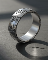Angled view of handcrafted silver ring with engraved Egyptian hieroglyphics and brushed metal finish