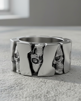 Angled view of handcrafted sterling silver biker ring with industrial gear design and skull motifs