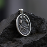 Oxidized 925 sterling silver medallion with skeleton couple design representing till death do us part on textured rock