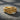 Close-up of gold vermeil koi fish ring featuring yin yang carp design on dark textured background