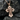 Close-up of 925 sterling silver Jesus cross pendant with intricate crown of thorns detailing resting on dark stone