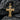 Detailed two-tone Jesus crucifix pendant resting on dark textured stone highlighting the wood grain cross design