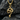 Close-up of the intricately carved snake pendant resting on a dark textured rock highlighting its scales.