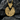 Close-up of a gold vermeil pizza slice pendant resting on dark textured stone highlighting the miniature food details