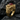 Close-up of premium gold vermeil twin ram ring showing intricate animal textures and red cabochon gem on rock