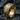Handcrafted ebb and flow ring in gold vermeil resting elegantly on dark natural stone, displaying intricate 3D textures.
