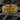 Detailed gold over 925 sterling silver Maltese cross ring resting on a dark stone showcasing deep vintage engravings