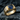 Luxurious 14K gold vermeil blue sapphire ring resting on dark stone, highlighting the deep blue centerpiece