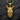 Close-up of gold rhinoceros pendant highlighting detailed facial features and oxidized silver accents on dark slate stone