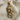 Close-up of the elegant ornamental skull pendant resting gracefully on textured beige linen fabric material