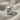 Round Skull Signet Ring, polished silver, angled view on fabric