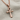 Beveled Ankh Pendant, rose gold, angled view on fabric